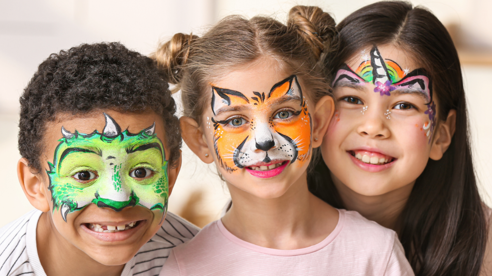 a trio of children with painted faces