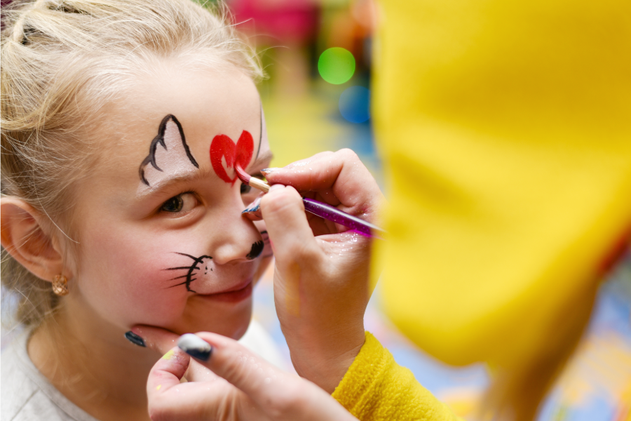 a face painter painting a child's face at a party in Richmond, VA